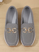 Close-up of silver gray mesh and gold-tone hardware