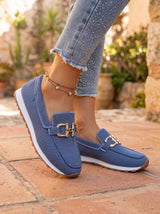 Woman wearing navy blue slip-on loafers