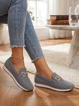 Woman wearing silver gray slip-on loafers