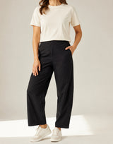 Black Aria barrel-leg pants on a model