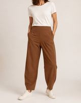 Brown Aria barrel-leg pants on a model