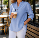 Light blue Elara blouse at an outdoor cafe